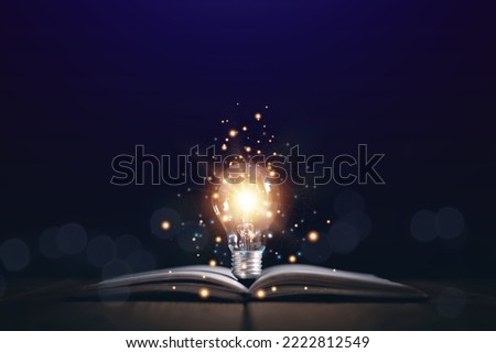 Educational knowledge and business education ideas, Innovations, Glowing light bulb on a book, self-learning, Inspiring from read concept, knowledge and searching for new ideas. Thinking for new idea. Royalty-Free Stock Photo #2222812549