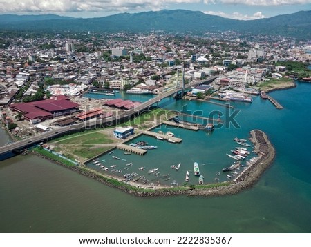 Manado City, North Sulawesi Province, Indonesia. view from above with boat harbor and landmark of the sukarno bridge. Royalty-Free Stock Photo #2222835367