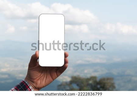 Woman hand holds modern white screen smartphone on floral background, Travel concept. Business office ideas. Choice of travel. Copy space. Online store. technology digital cyberspace. web network.