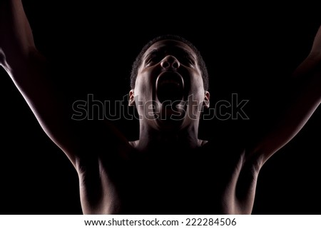 screaming unknown man with the face in the shadow