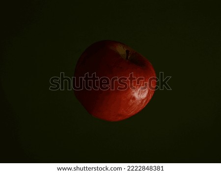 Flying Apple Captured in Dark Background
