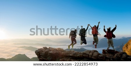 Group of happy hiker jumping on the hill. hiking holiday, wild adventure Royalty-Free Stock Photo #2222854973