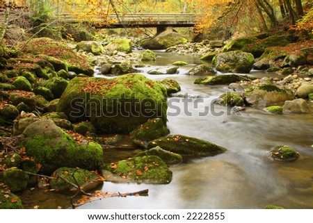 Autumn scene with flowing river taken with slow shutter speed on a tripod and lowest ISO.