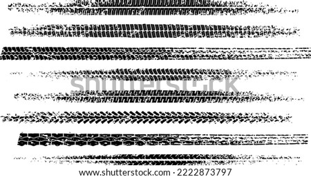 Set of black motorcycle tire tread print with grunge effect isolated on white background. Footprint of bike or car wheels with seamless texture. Top view of rubber protector marks. Vector brush Royalty-Free Stock Photo #2222873797