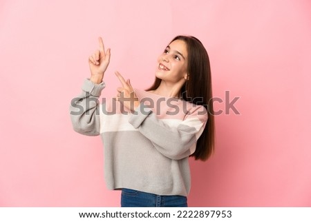 Little girl isolated on pink background pointing with the index finger a great idea