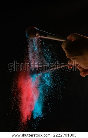 High speed action with powder in cosmetics photography , black background, selective focus.


