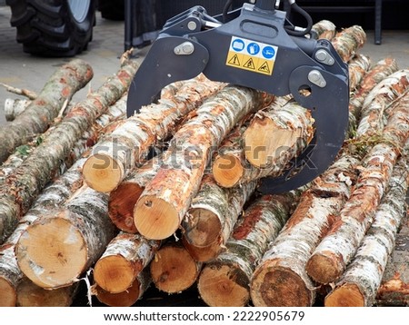 Hydraulic log gripper in logging   Royalty-Free Stock Photo #2222905679