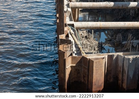 Cofferdam for the repair of the river bank. Protection against flooding. Background picture.