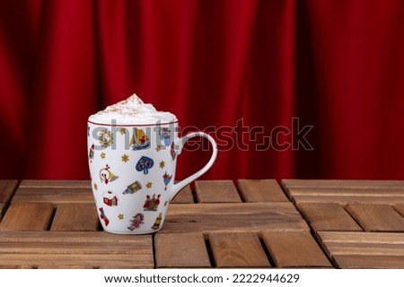 cappuccino in christmas mug on red background