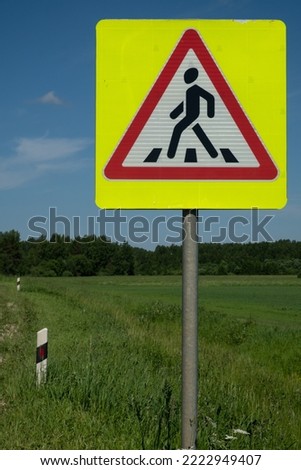 Road sign "Pedestrian crossing" Warning sign. Summer. Day.