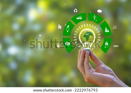 Renewable Energy. Hand holding light bulb and have green world map with icons energy sources for renewable, sustainable development. green energy concept energy sources sustainable Ecology Elements. Royalty-Free Stock Photo #2222976793