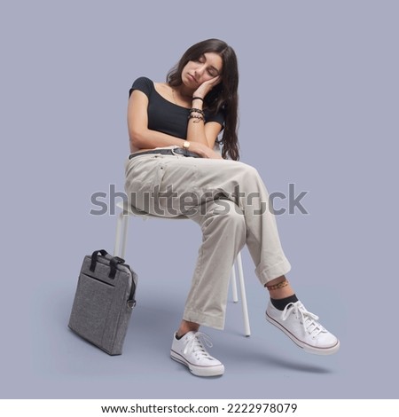 Young tired woman sitting on a chair and sleeping