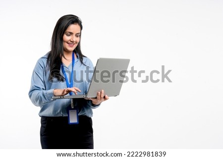 Indian businesswoman or employee using laptop on white background. Royalty-Free Stock Photo #2222981839