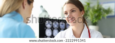Pregnant woman at doctor appointment, ultrasound picture