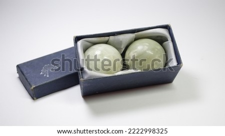 Baoding Balls. Hand training with traditional Chinse medical balls (Baoding balls) which is beneficial for health.Close-up shot of a male hand holding baoding balls, isolated on white background.