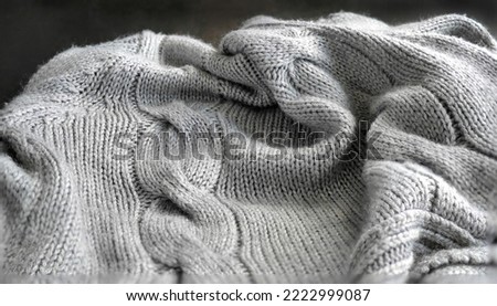 Selective focus Knitted Woolen, Knitwear Fabric Texture, Warm Clothes for Fall and Winter, Woven, Woolen, Sweaters, gray color with Dark Background and copy space