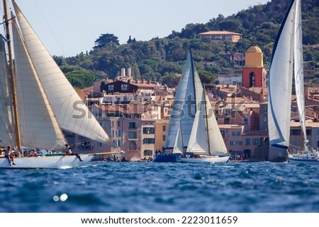 Sailboats in front of the village of Saint Tropez in France during a race Royalty-Free Stock Photo #2223011659