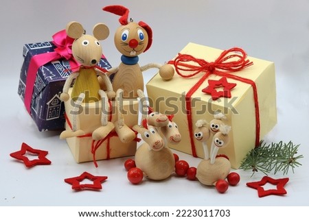 Christmas gifts and Traditional wooden toys, a mouse, a bunny and two little three-headed dragons