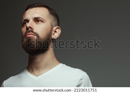 Male beauty concept. Portrait of proud charismatic active 30-year-old man posing over dark gray background. Perfect haircut. Hipster style. Close up. Copy-space. Studio shot Royalty-Free Stock Photo #2223011751