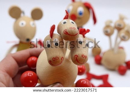 Traditional wooden toy, little three-headed dragon and other toys in the background