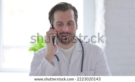 Portrait of Young Doctor Talking on Phone