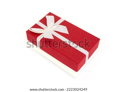 White gift box with red cover placed and tie a bow isolated on white background.