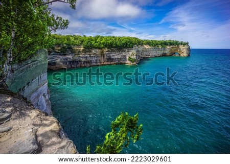 Pictured Rocks National Lakeshore - Scenic Great Lakes Shoreline Landscape - Pure Michigan Lake Superior Shoreline At Grand Portal Point - A Natural Arch In Cliffs Meet Water Royalty-Free Stock Photo #2223029601