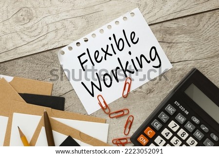 Flexible working policy concept. text on a torn page. red paper clip calculator Royalty-Free Stock Photo #2223052091