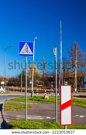 Railroad crossing with barrier and signs