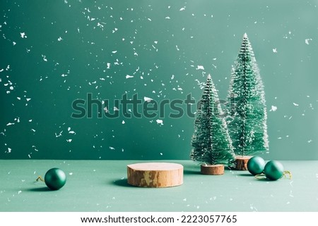 Minimalistic festive empty scene showcase for product, green background, tree Christmas toys, snow