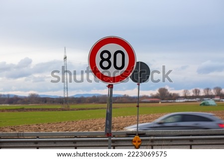 Traffic sign 80 on the German autobahn. Speed limit 80. Natural light, selective focus. 
