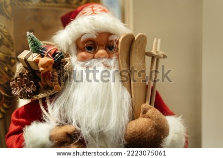 Christmas concept. A toy of Santa Claus with skis stands in a shop window and creates a festive mood.