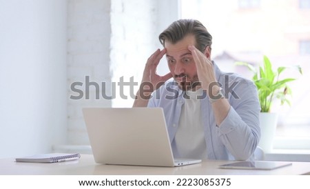 Angry Young Man Working on Laptop in Office