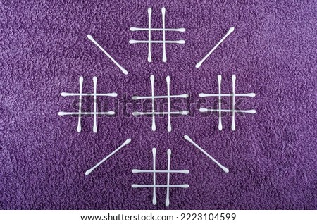 cotton swabs hashtag on background purple towel