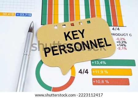 Business concept. On the business charts is a pen and a sign with the inscription - Key Personnel