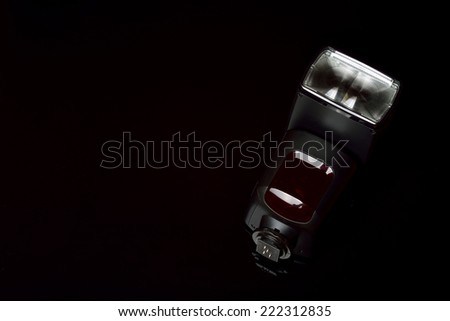 Camera flash on a black background,  focus on reflector,