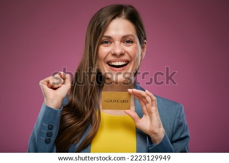 Laughing woman holding credit card. Close up face isolated advertising portrait on pink back. 