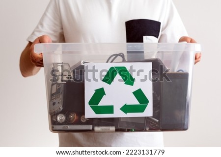 Household electrical and scrapped electronic devices in recycle container. Sorting, disposing and recycling. Waste Electrical and Electronic Equipment. Hazardous E-Waste Recycling.  Royalty-Free Stock Photo #2223131779