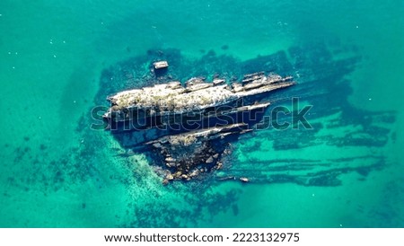 Aerial shot of Rock in the sea