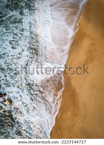Aerial views of crashing waves at the beach
