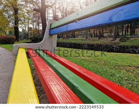 Creative colorful street park wooden bench painted in bright colors