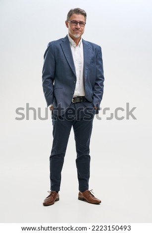 Full length portrait of confident businessman. Entrepreneur in business casual, smiling, Happy mid adult, mature age man standing, smiling, isolated on white background. Royalty-Free Stock Photo #2223150493