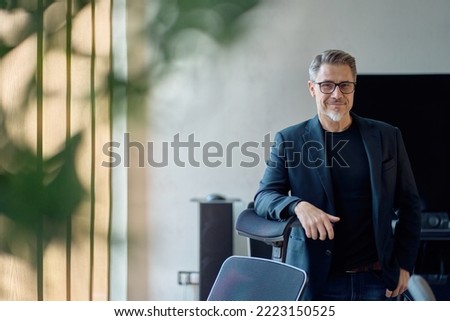 Portrait of confident businessman in business casual. Happy middle aged, mid adult, mature age man smiling. Entrepreneur in modern office. Royalty-Free Stock Photo #2223150525