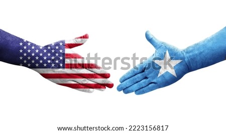Handshake between Somalia and USA flags painted on hands, isolated transparent image.