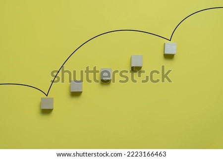 wooden blocks with the line as symbol of rise and increase on pastel background 