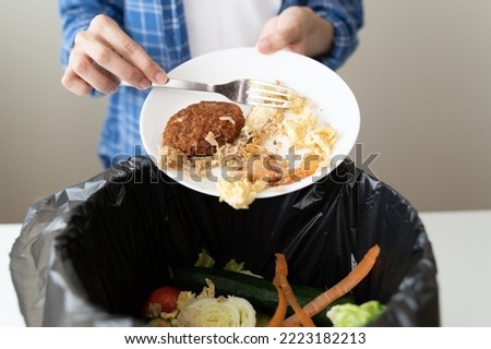 people put bio trash from food waste in domestic homes to compost bins to make fertilizer to reduce global environmental pollution. Royalty-Free Stock Photo #2223182213