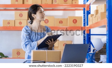 Small Business Startup SME Owner Asian Woman Checking Laptop Online Orders Sell ​​products that work with boxes. Work independently at home, online SME business