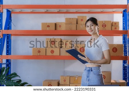 Small Business Startup SME Owner Asian Woman Checking Laptop Online Orders Sell ​​products that work with boxes. Work independently at home, online SME business