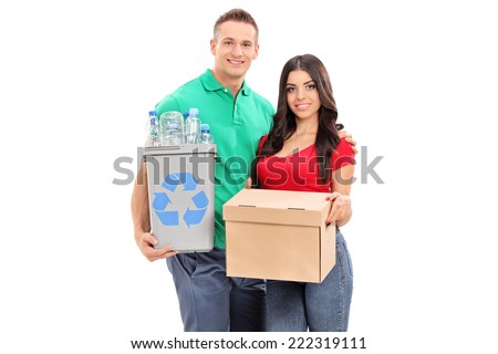 Young couple holding recycle bin and a box isolated on white background