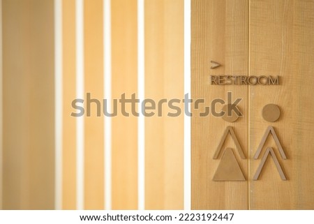 Restroom icon on wooden background and copy space.